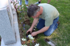 My husband planting marigolds at his mother's grave